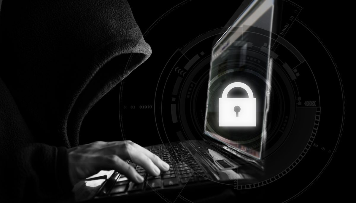 Internet network security system. Hacker in black hoodie using computer laptop and technology lock system